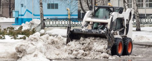 loader removes snow on city streets loader removes snow on city streets